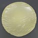 Glazed stoneware plate with carved ripple decoration